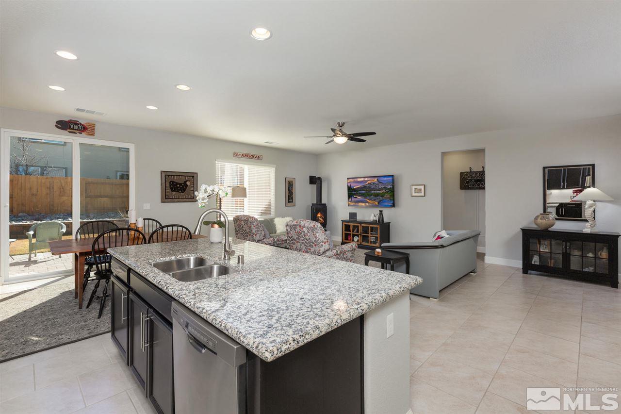 1830 Cascade Stable Lane Reno, NV 89521 - Photo 10 of 25 a kitchen with granite countertop a sink a counter top space and living room view