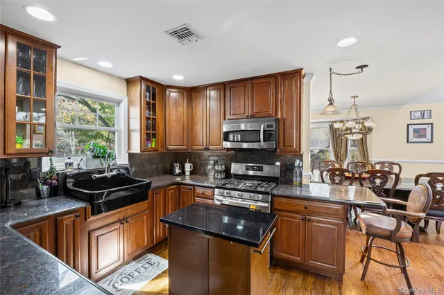 a kitchen with stainless steel appliances granite countertop a refrigerator stove and microwave