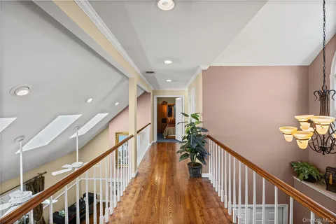 a living room with chairs and a wooden floor