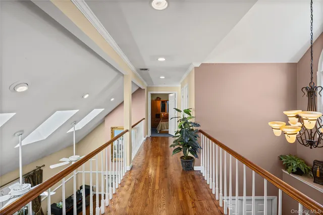 a living room with chairs and a wooden floor