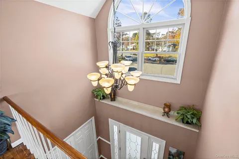 a front view of a house with wooden stairs and fence