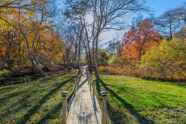a view of a house with swimming pool and sitting area