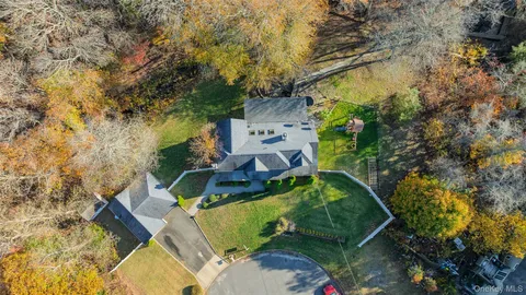 an aerial view of a house with a yard basket ball court and outdoor seating