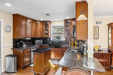 a kitchen with stainless steel appliances granite countertop a sink stove and microwave