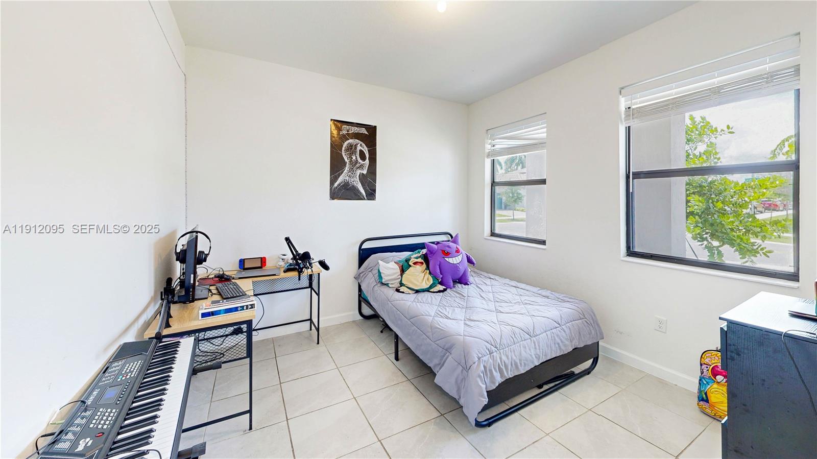 11964 Southwest 244th Street Homestead, FL 33032 - Photo 13 of 62 a bedroom with a bed and a window