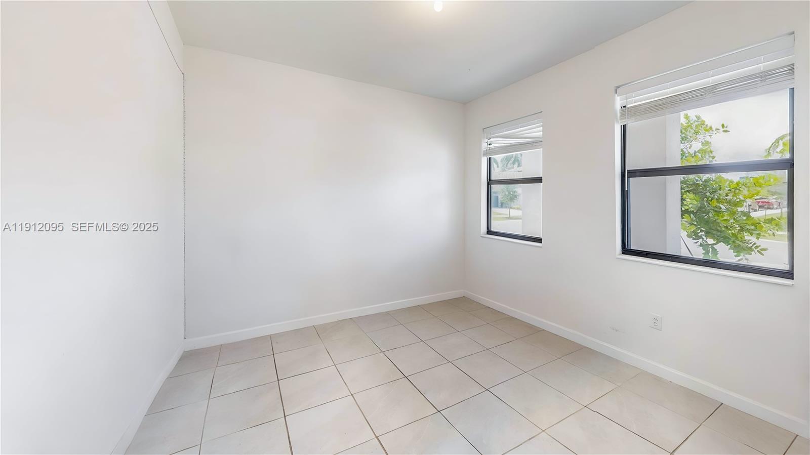 11964 Southwest 244th Street Homestead, FL 33032 - Photo 14 of 62 an empty room with windows