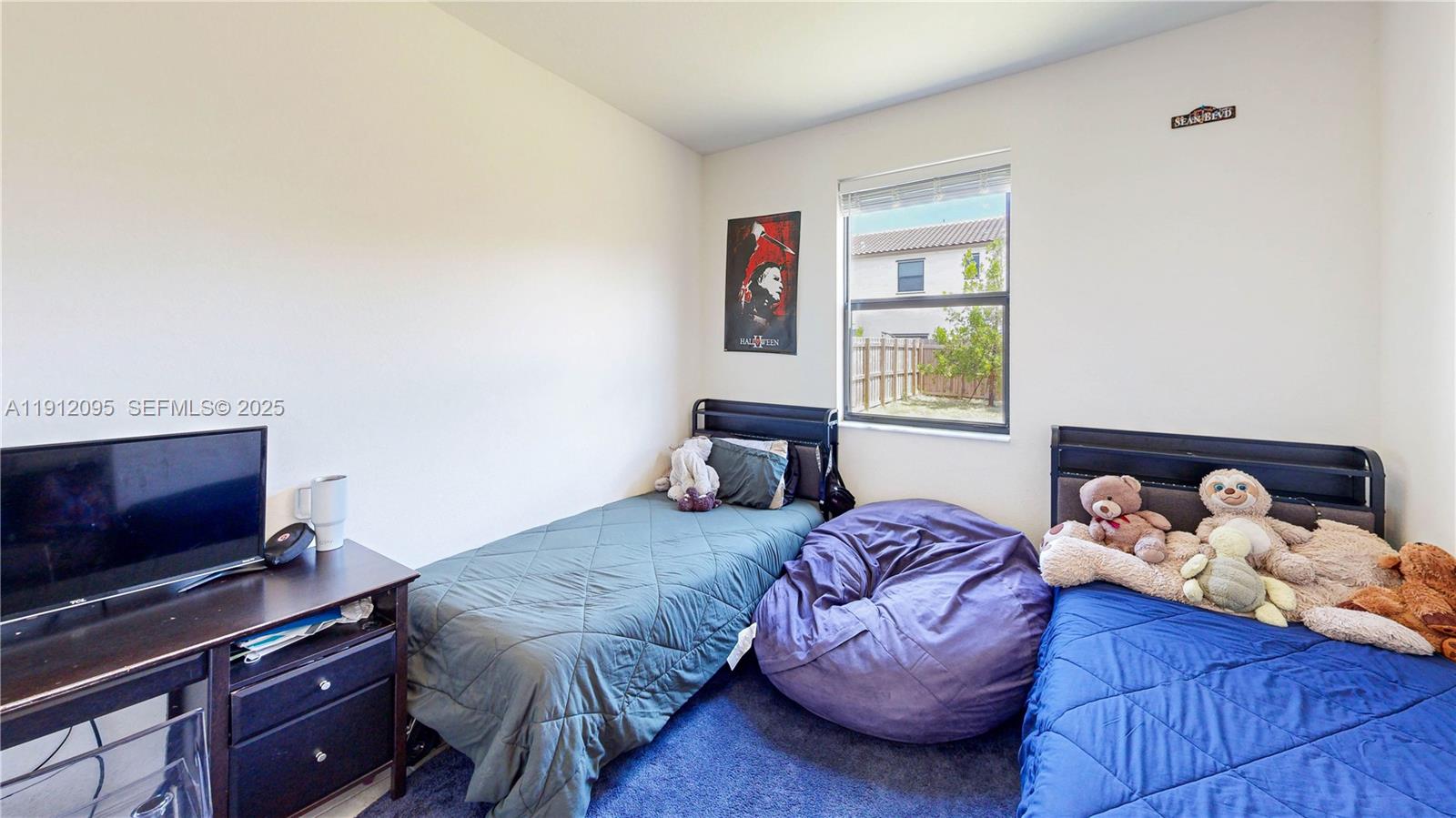 11964 Southwest 244th Street Homestead, FL 33032 - Photo 17 of 62 a bedroom with a bed and flat screen tv