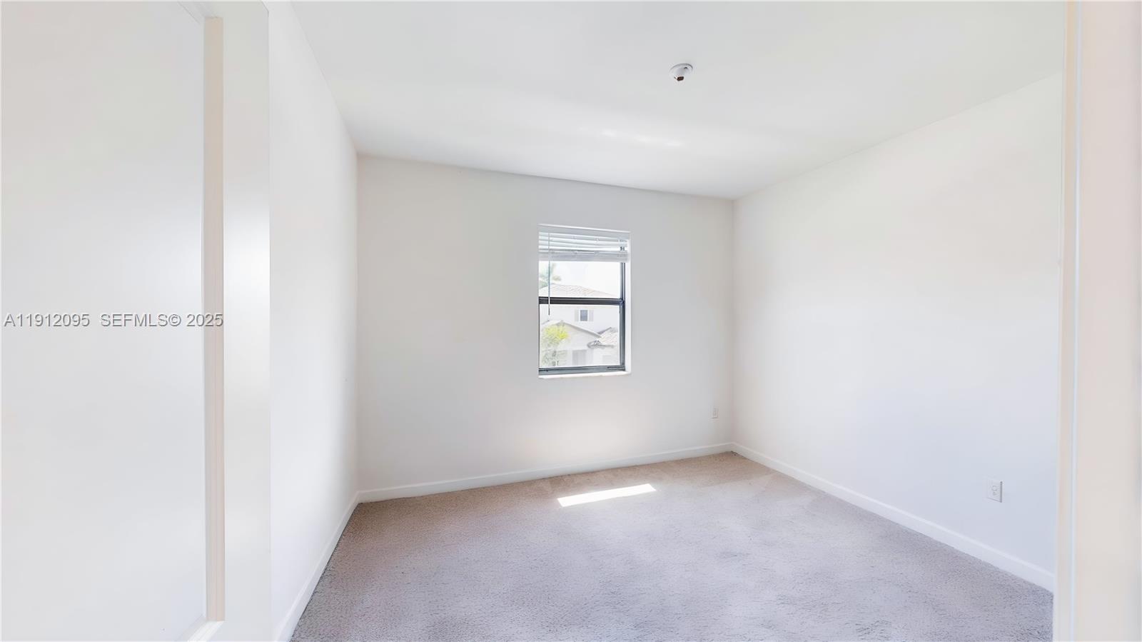 11964 Southwest 244th Street Homestead, FL 33032 - Photo 23 of 62 a view of an empty room with a window