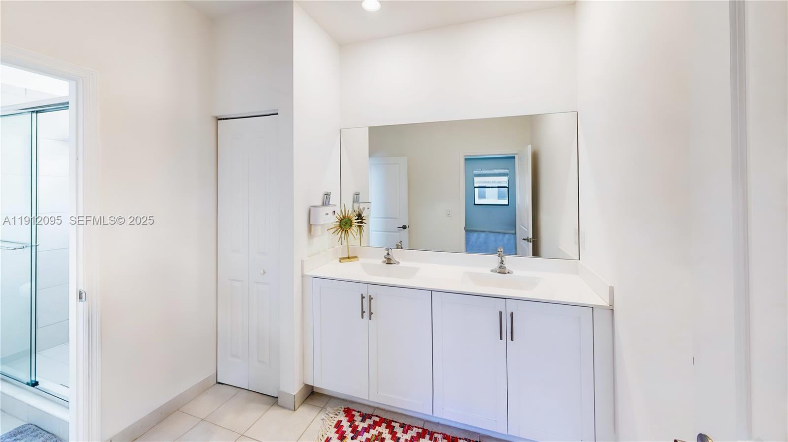 11964 Southwest 244th Street Homestead, FL 33032 - Photo 35 of 62 a bathroom with a sink and a mirror