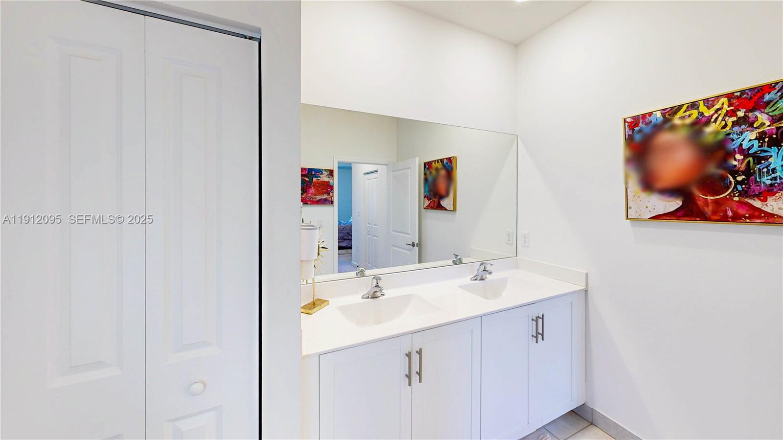 11964 Southwest 244th Street Homestead, FL 33032 - Photo 37 of 62 a bathroom with a sink mirror and vanity
