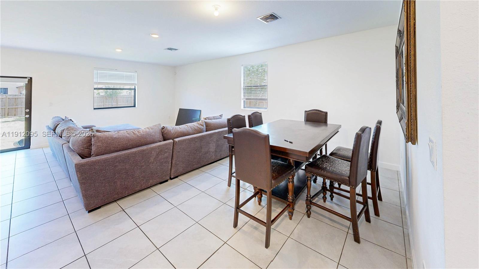 11964 Southwest 244th Street Homestead, FL 33032 - Photo 7 of 62 a living room with furniture and a window