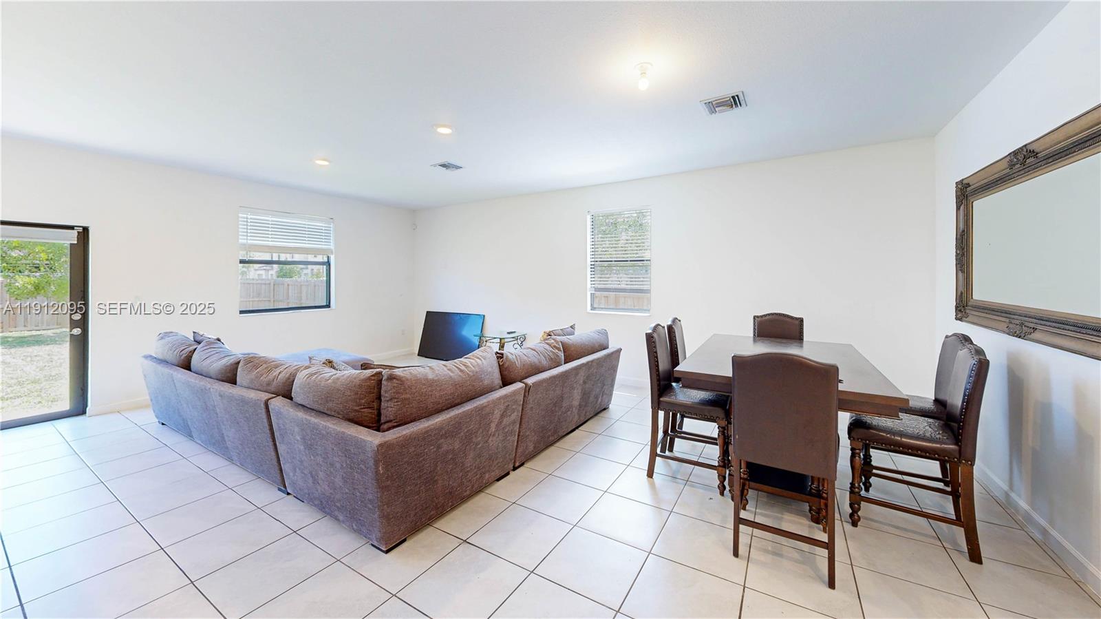 11964 Southwest 244th Street Homestead, FL 33032 - Photo 8 of 62 a living room with furniture and a flat screen tv