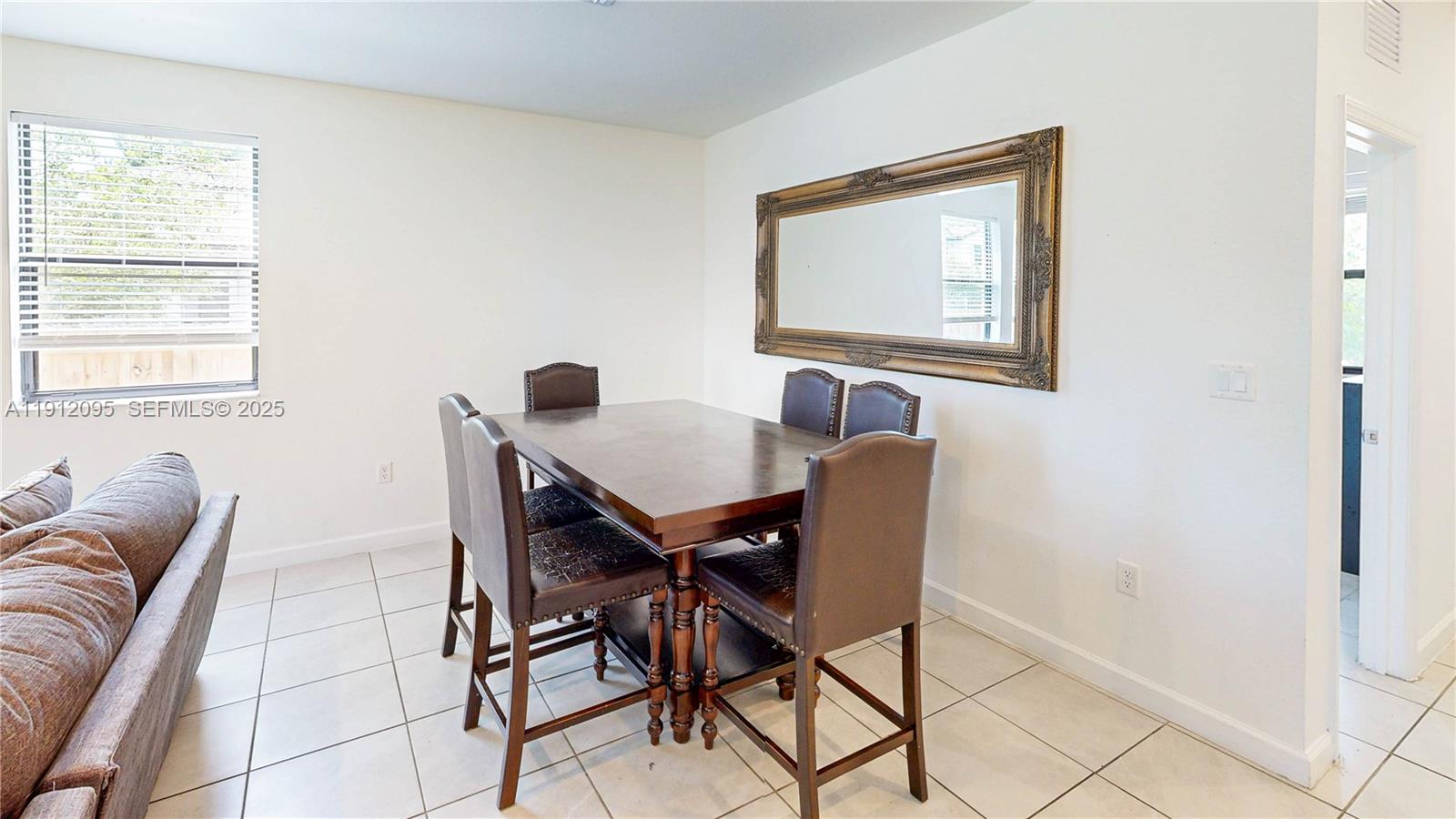 11964 Southwest 244th Street Homestead, FL 33032 - Photo 9 of 62 a view of a dining room with furniture and window