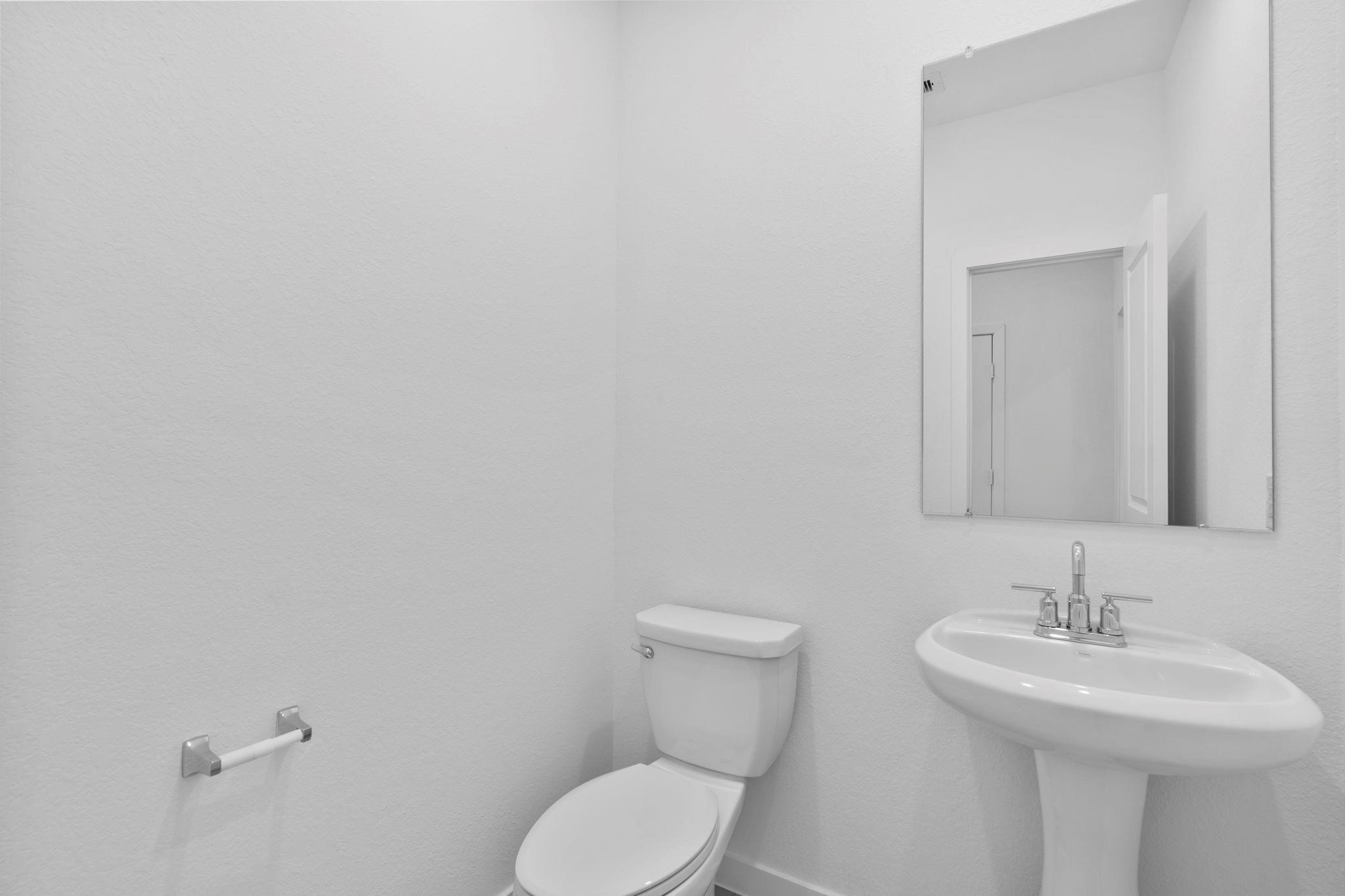 2716 Pine Bluff Drive Rosenberg, TX 77469 - Photo 13 of 32 a bathroom with a toilet sink and mirror