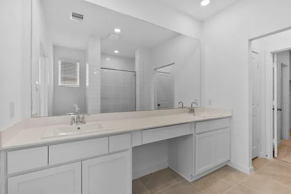 a bathroom with double sink and a mirror