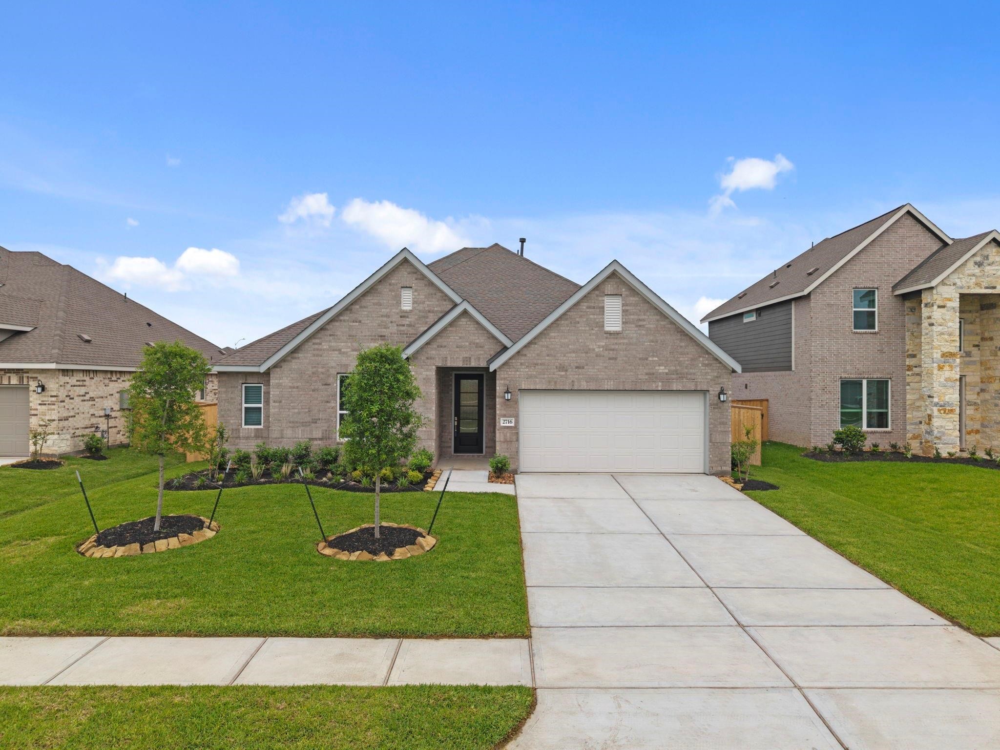 2716 Pine Bluff Drive Rosenberg, TX 77469 - Photo 2 of 32 a front view of a house with a yard and garage