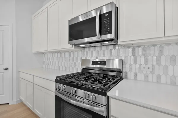 a stove top oven sitting inside of a kitchen