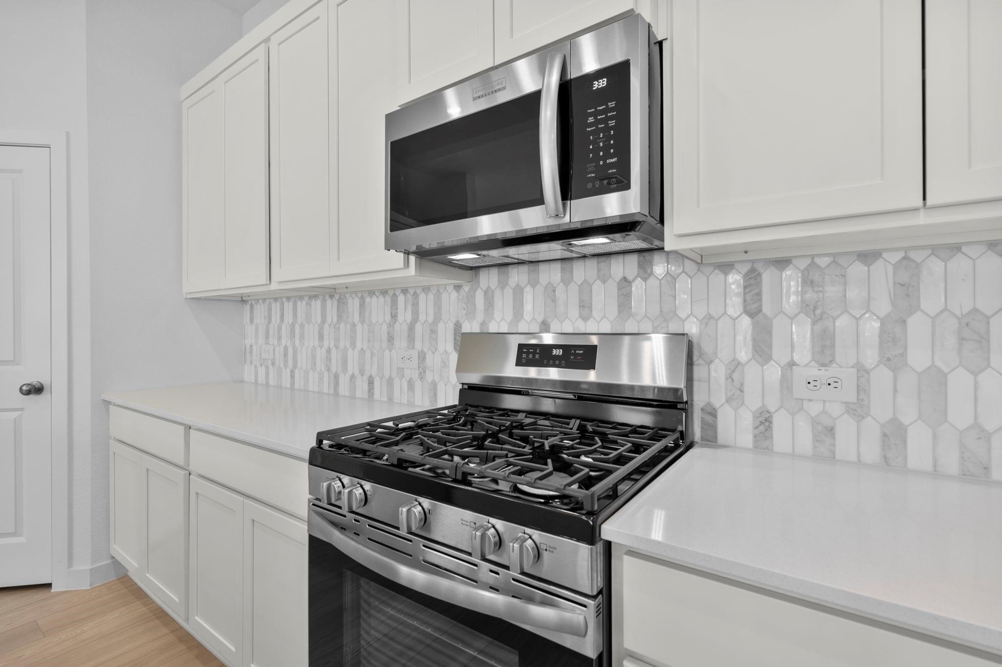 2716 Pine Bluff Drive Rosenberg, TX 77469 - Photo 9 of 32 a stove top oven sitting inside of a kitchen