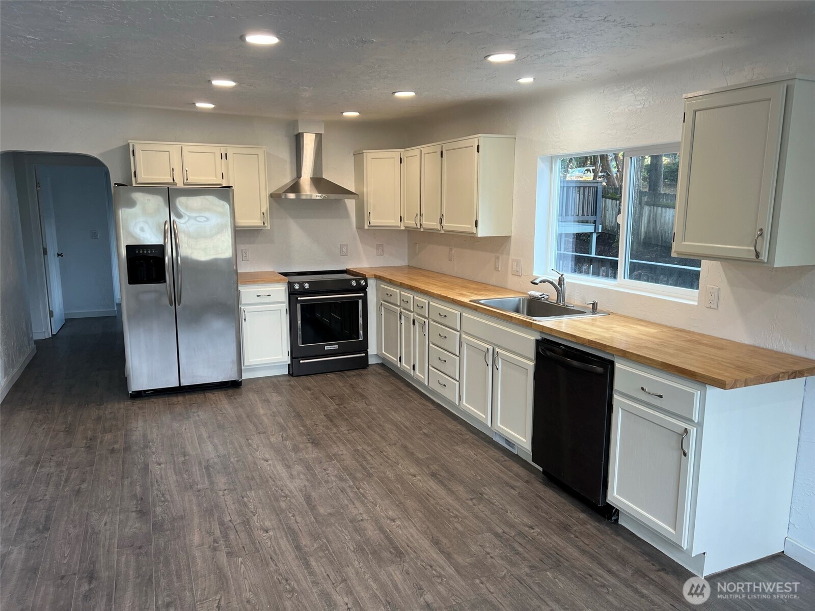 1663 Harrison Avenue Southeast Port Orchard, WA 98366 - Photo 12 of 30 a large kitchen with stainless steel appliances granite countertop a stove a sink and a refrigerator