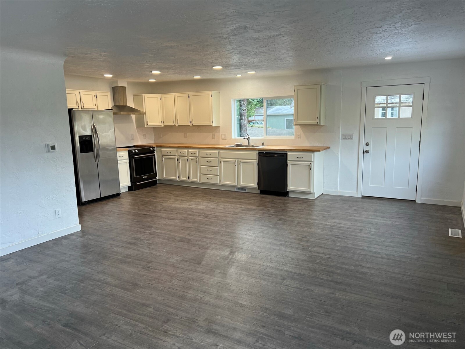 1663 Harrison Avenue Southeast Port Orchard, WA 98366 - Photo 13 of 30 a large kitchen with stainless steel appliances granite countertop a large counter top a sink and a stove
