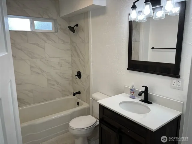 a bathroom with a sink toilet a mirror and shower