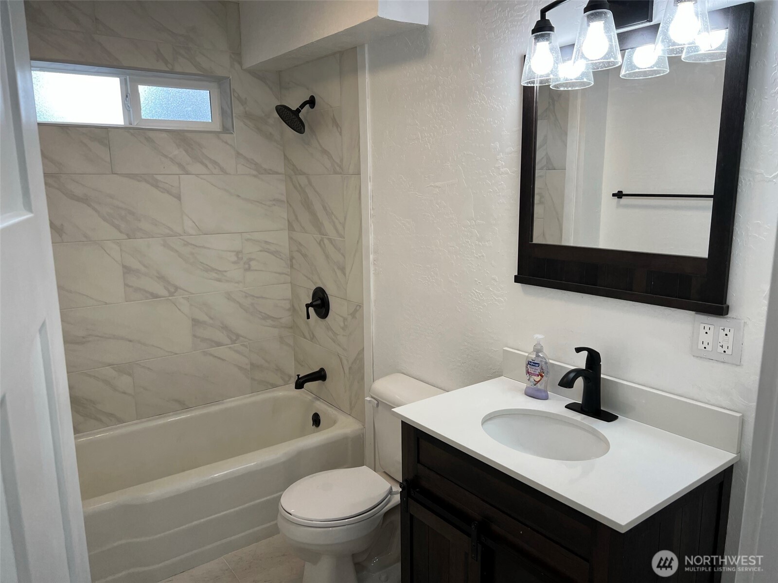 1663 Harrison Avenue Southeast Port Orchard, WA 98366 - Photo 16 of 30 a bathroom with a sink toilet a mirror and shower