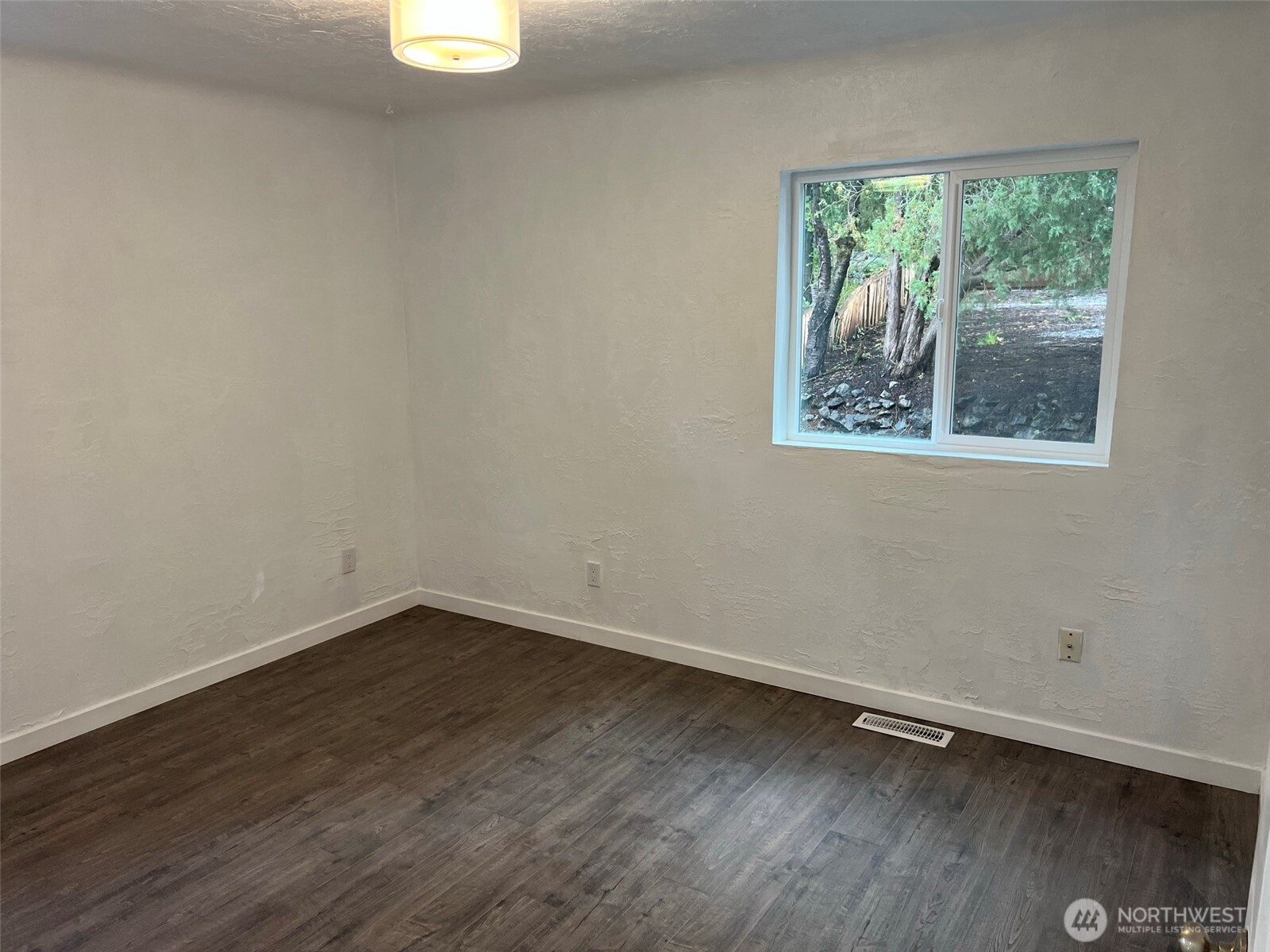 1663 Harrison Avenue Southeast Port Orchard, WA 98366 - Photo 18 of 30 an empty room with wooden floor and window