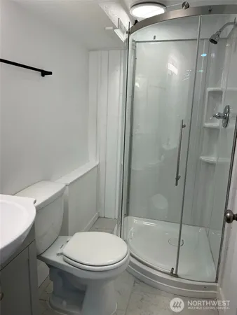 a white toilet sitting next to a bath tub shower