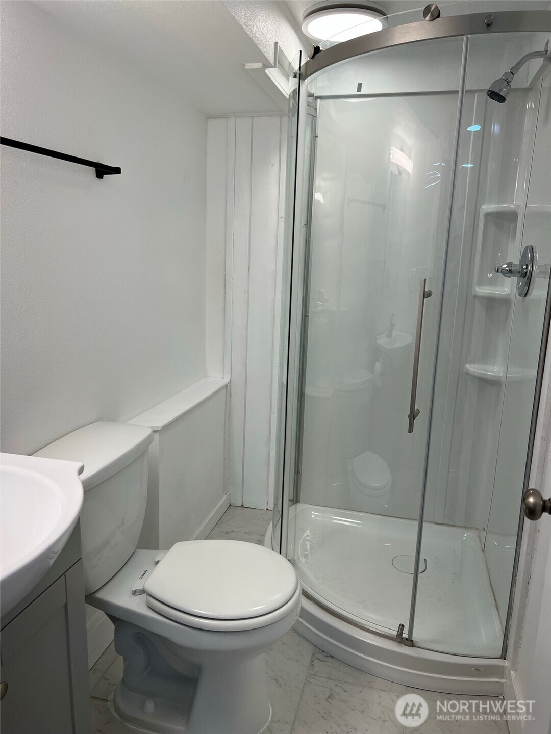 1663 Harrison Avenue Southeast Port Orchard, WA 98366 - Photo 6 of 30 a white toilet sitting next to a bath tub shower