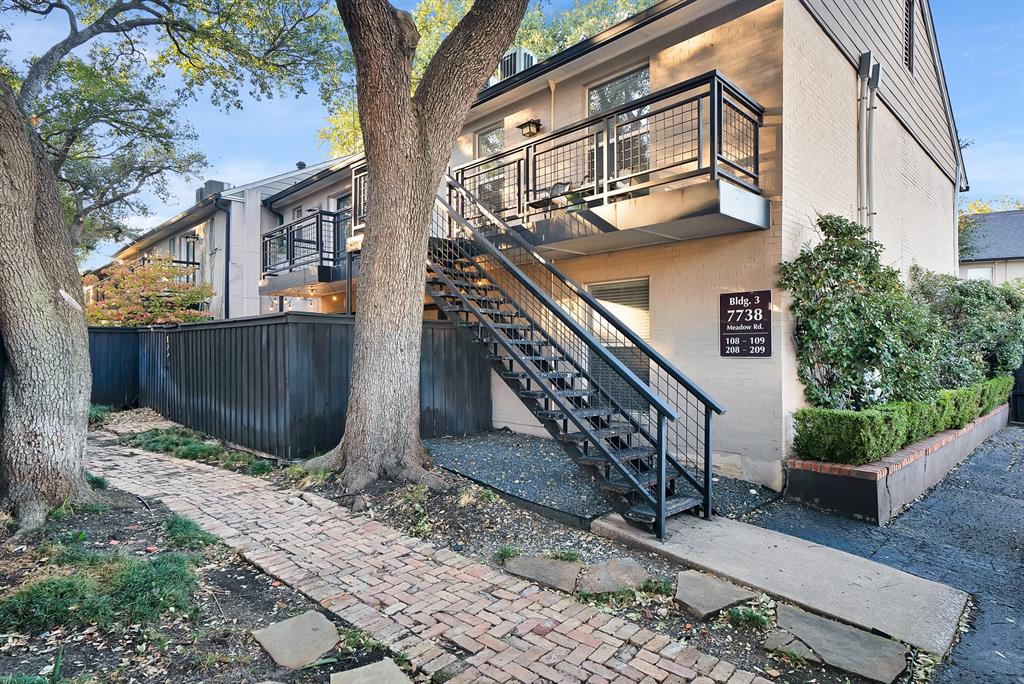 7738 Meadow Road, Unit 109 Dallas, TX 75230 - Photo 1 of 35 a front view of a house with a yard