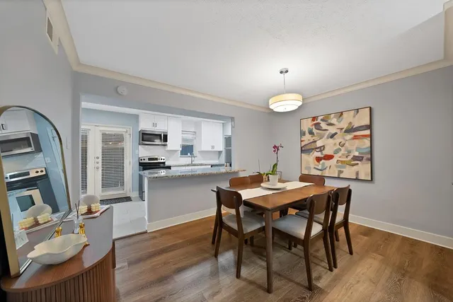 a view of a dining room with furniture and wooden floor