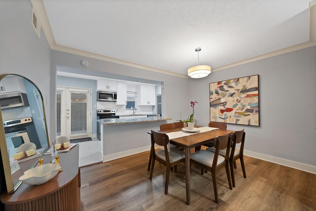 7738 Meadow Road, Unit 109 Dallas, TX 75230 - Photo 12 of 35 a view of a dining room with furniture and wooden floor