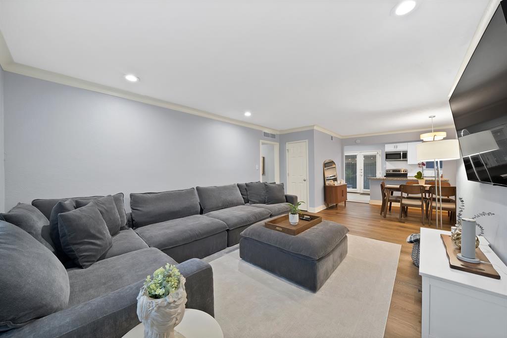 7738 Meadow Road, Unit 109 Dallas, TX 75230 - Photo 14 of 35 a living room with furniture and a flat screen tv