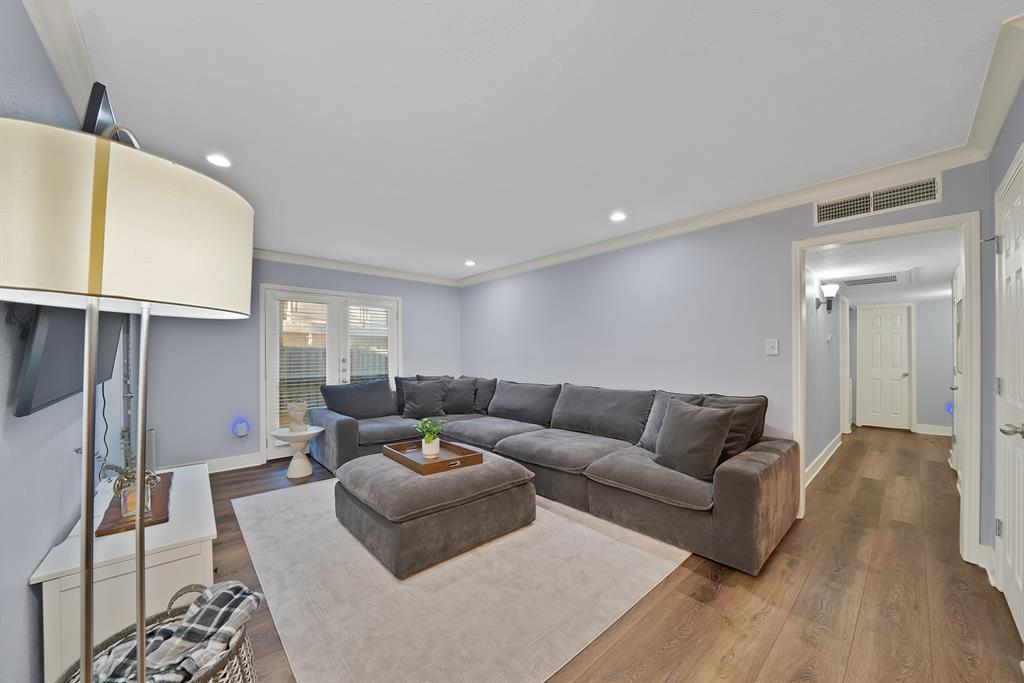 7738 Meadow Road, Unit 109 Dallas, TX 75230 - Photo 15 of 35 a living room with furniture and a wooden floor