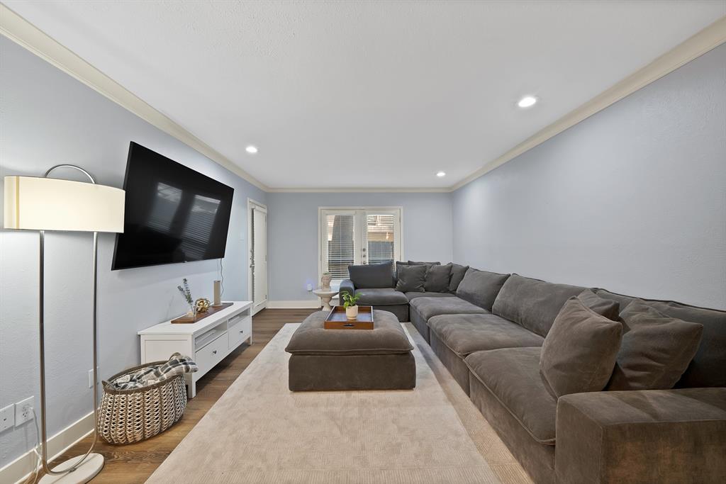 7738 Meadow Road, Unit 109 Dallas, TX 75230 - Photo 16 of 35 a living room with furniture and a flat screen tv