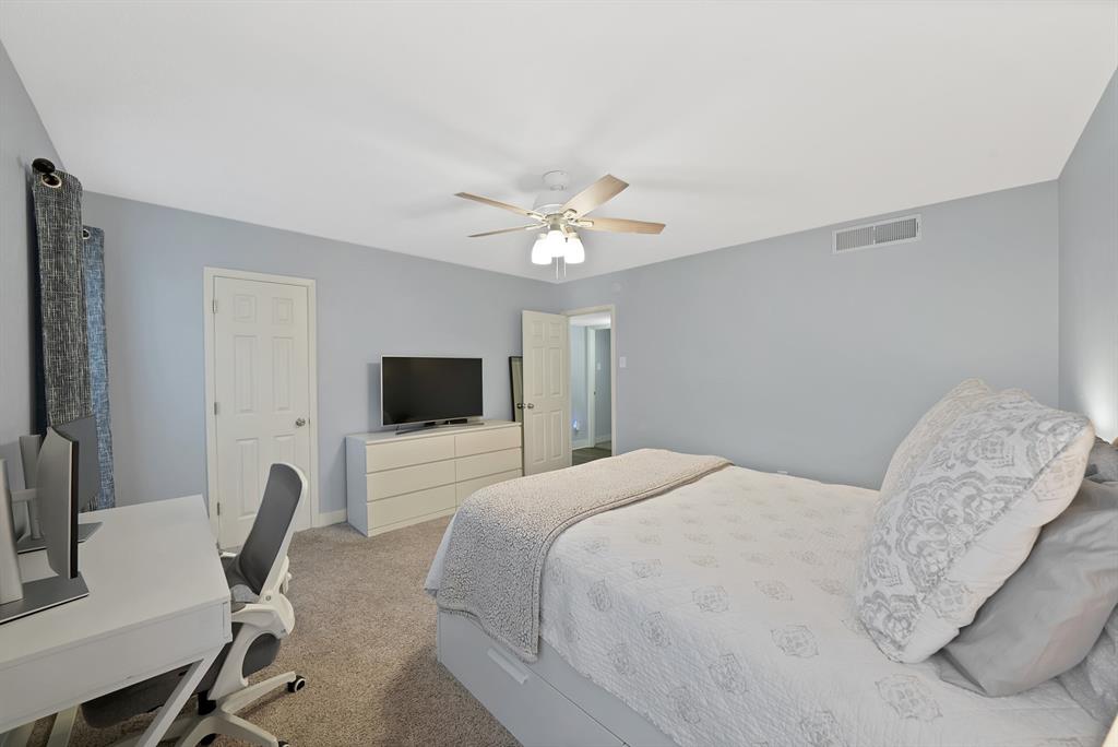 7738 Meadow Road, Unit 109 Dallas, TX 75230 - Photo 19 of 35 a bedroom with a bed and a chair