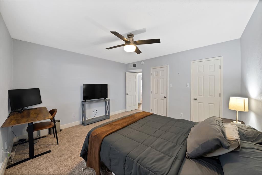 7738 Meadow Road, Unit 109 Dallas, TX 75230 - Photo 20 of 35 a bedroom with a bed and a flat screen tv
