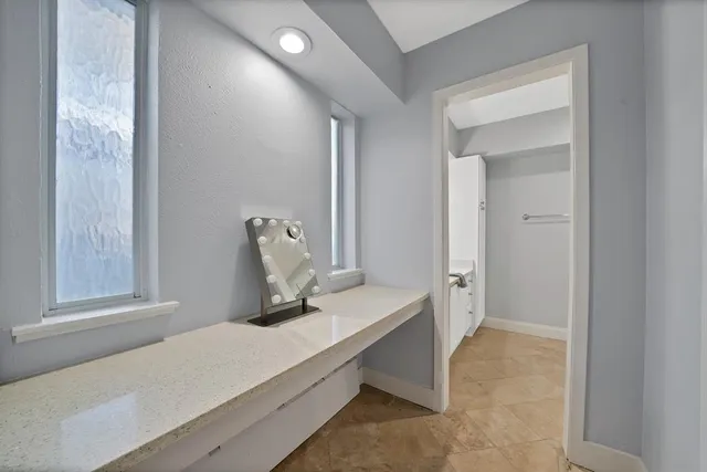 a room with a table chairs and wooden floor