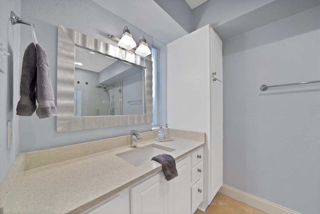 7738 Meadow Road, Unit 109 Dallas, TX 75230 - Photo 22 of 35 a bathroom with a sink and a mirror