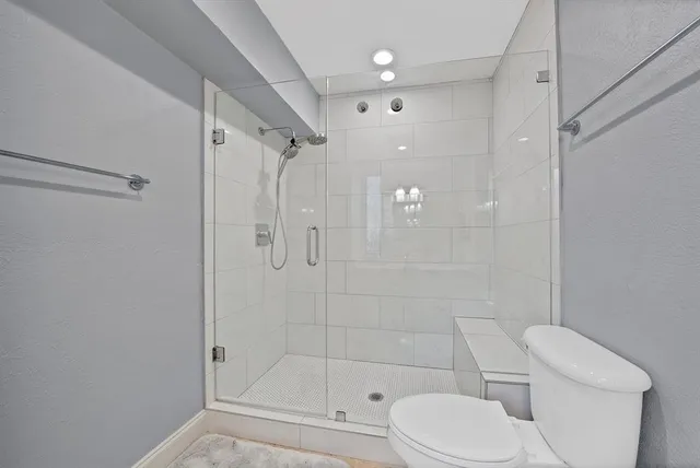 a bathroom with a toilet and shower