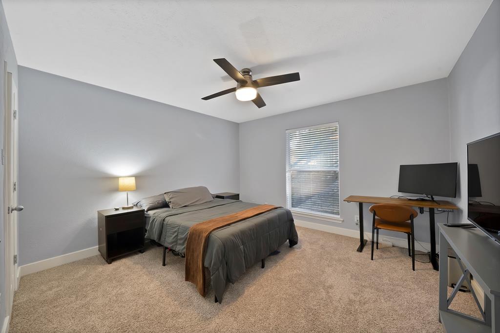 7738 Meadow Road, Unit 109 Dallas, TX 75230 - Photo 24 of 35 a bedroom with a bed and a chandelier