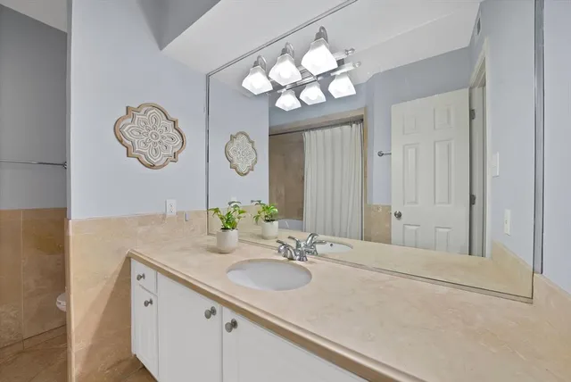 a bathroom with a sink vanity and a mirror
