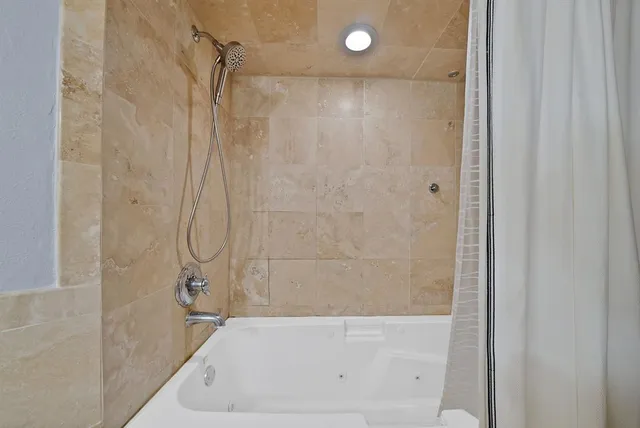 a bathroom with a bathtub and a shower