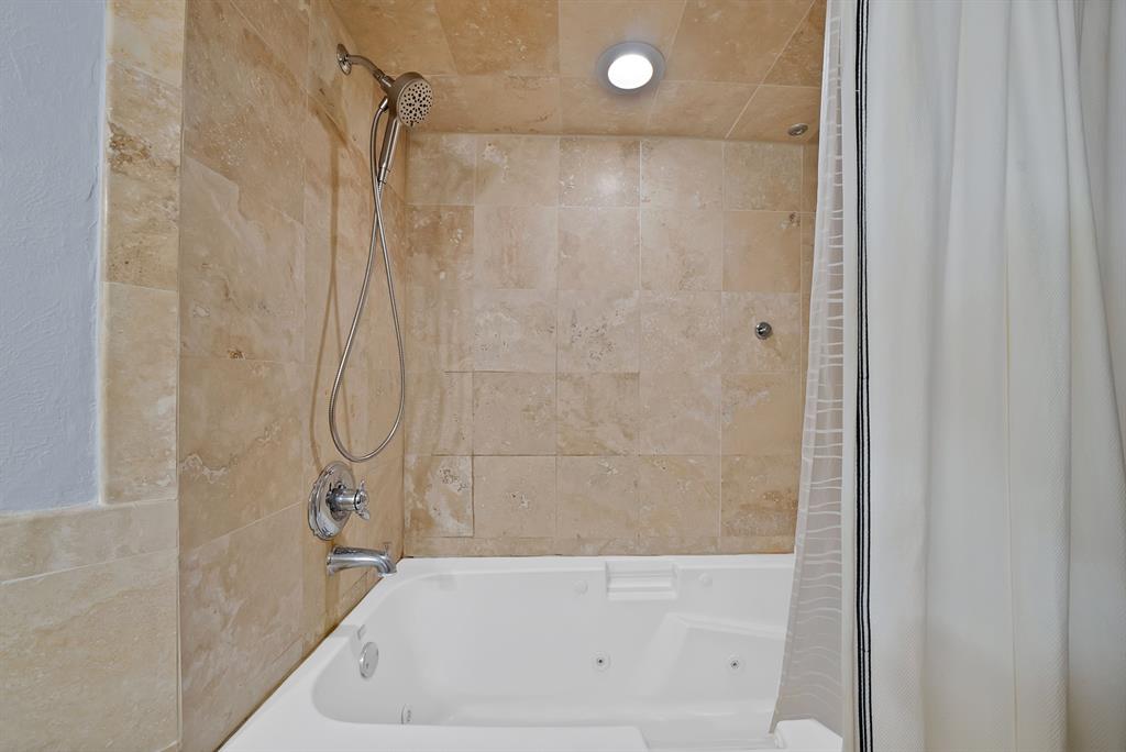7738 Meadow Road, Unit 109 Dallas, TX 75230 - Photo 26 of 35 a bathroom with a bathtub and a shower