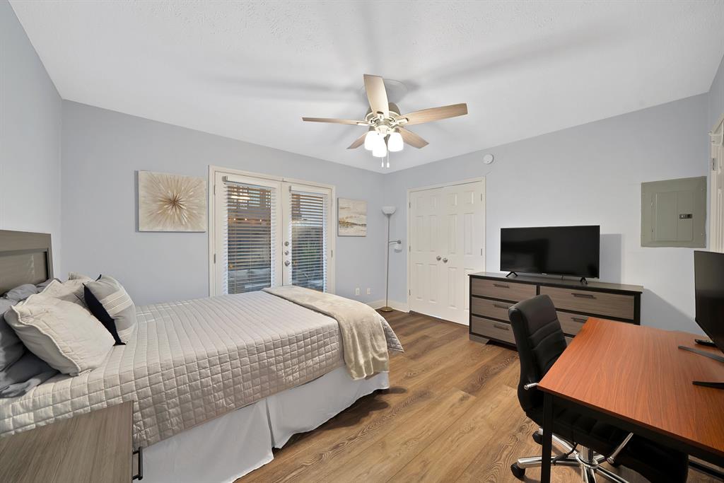 7738 Meadow Road, Unit 109 Dallas, TX 75230 - Photo 28 of 35 a bedroom with a bed and a flat screen tv