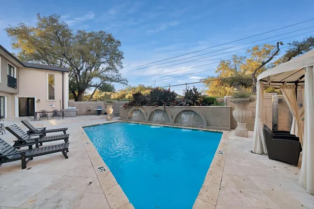 a view of a swimming pool with a patio