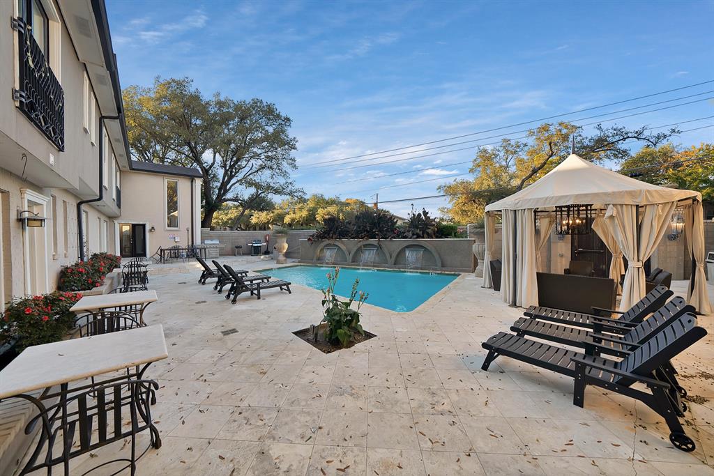 7738 Meadow Road, Unit 109 Dallas, TX 75230 - Photo 34 of 35 a view of a patio with a table chairs and a fire pit