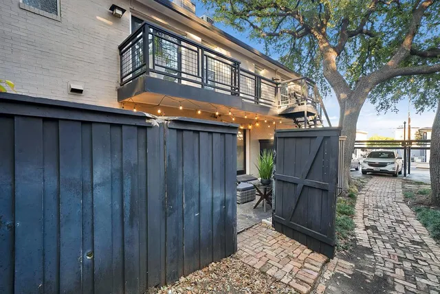 a backyard of a house with table and chairs