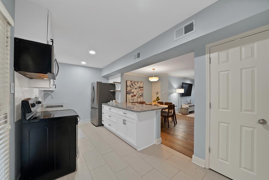 7738 Meadow Road, Unit 109 Dallas, TX 75230 - Photo 6 of 35 a living room with furniture and a flat screen tv