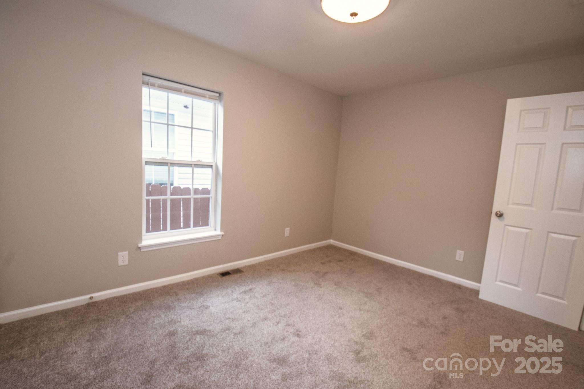 707 Summit Street Monroe, NC 28112 - Photo 17 of 23 an empty room with a window